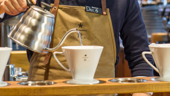 Barista preparando café con técnica Starbucks Coffee Craft